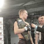 Vovka Clay, left, holding the lightweight title belt that he won on Feb. 25 at AFL 1.